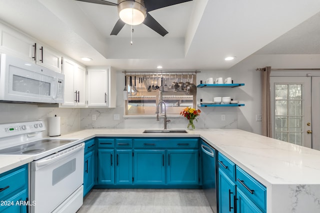 kitchen featuring blue cabinetry, white cabinets, white appliances, and sink