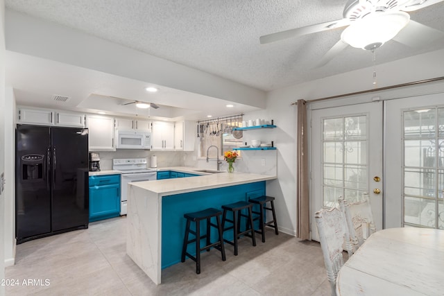 kitchen featuring white appliances, white cabinets, blue cabinets, sink, and kitchen peninsula