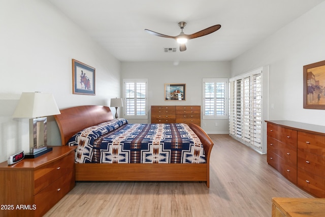 bedroom with baseboards, ceiling fan, visible vents, and light wood-style floors