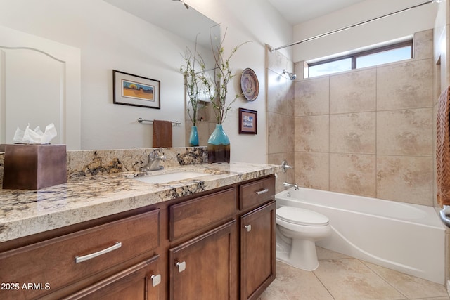 bathroom featuring tile patterned floors, vanity, toilet, and shower / bathtub combination