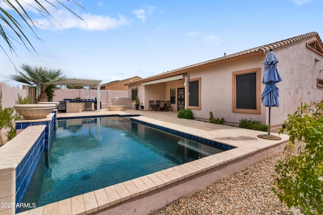 view of swimming pool featuring a patio area, a fenced backyard, and a jacuzzi