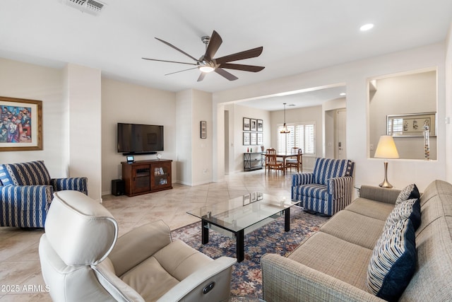 living area featuring light tile patterned floors, recessed lighting, visible vents, a ceiling fan, and baseboards