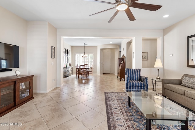 living room featuring ceiling fan, light tile patterned flooring, baseboards, and recessed lighting