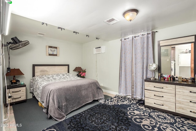 bedroom with an AC wall unit