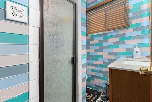 bathroom featuring vanity and a shower with shower door