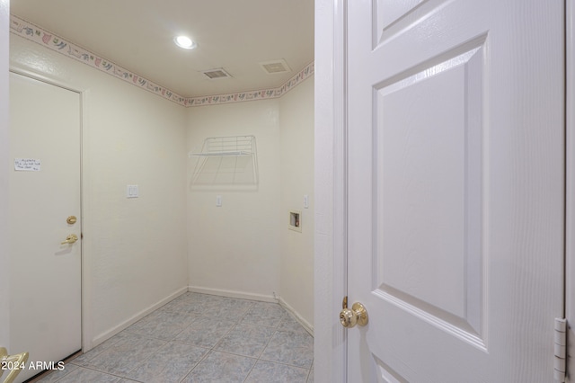 washroom featuring hookup for a washing machine and light tile patterned floors