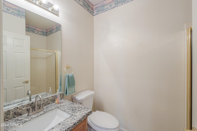 bathroom with vanity, toilet, and walk in shower