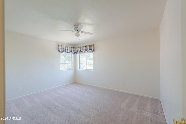 carpeted empty room featuring ceiling fan