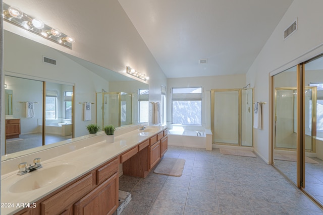 bathroom featuring lofted ceiling, tile patterned floors, separate shower and tub, and vanity