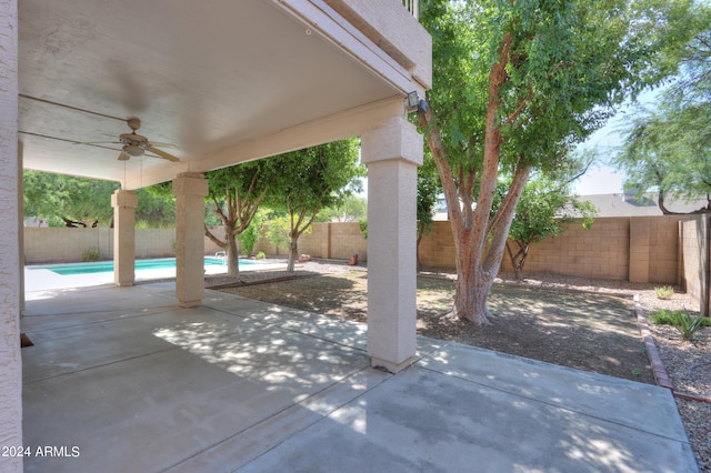 view of patio featuring a fenced in pool and ceiling fan