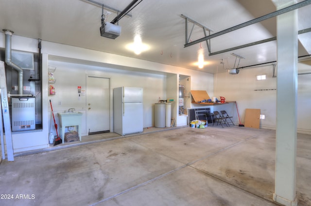 garage with white fridge and a garage door opener