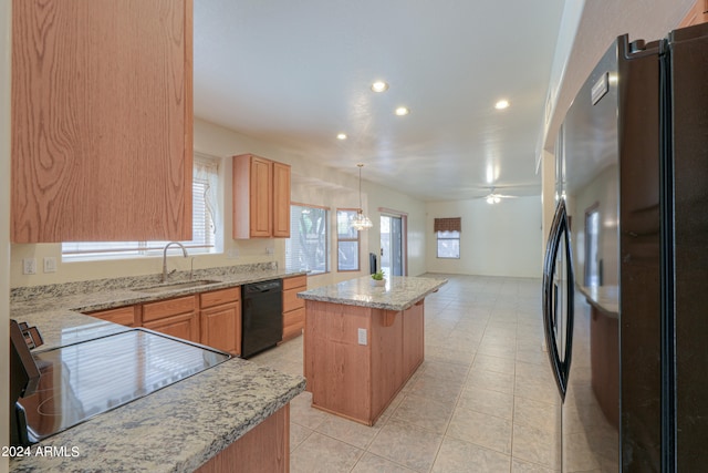 kitchen featuring a kitchen island, black dishwasher, pendant lighting, sink, and refrigerator