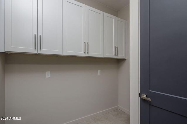 laundry room with baseboards