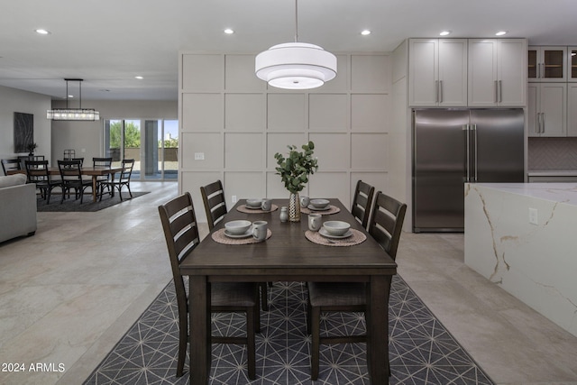 dining space featuring recessed lighting and a decorative wall