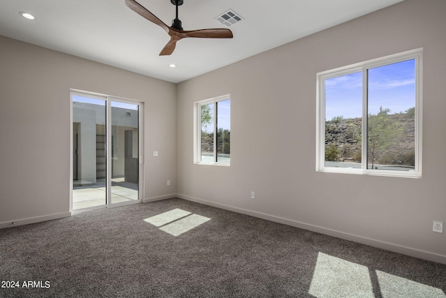 spare room with carpet floors, recessed lighting, visible vents, and baseboards