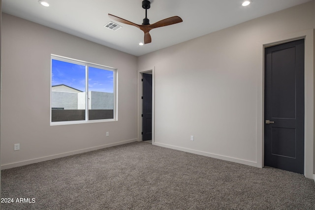 spare room with recessed lighting, carpet flooring, visible vents, and baseboards