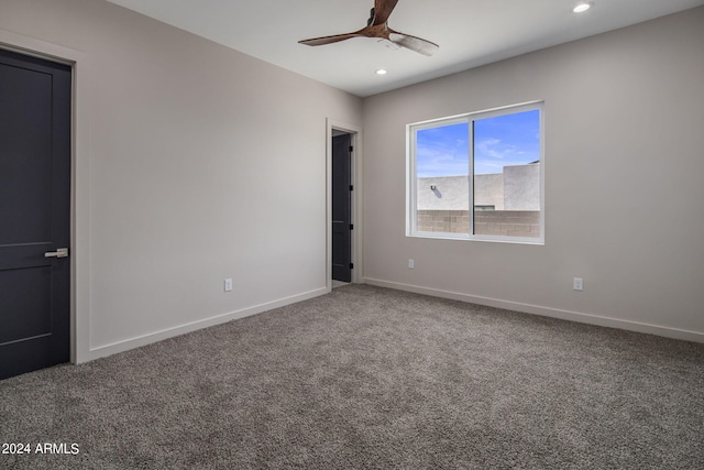 spare room with carpet, a ceiling fan, and baseboards