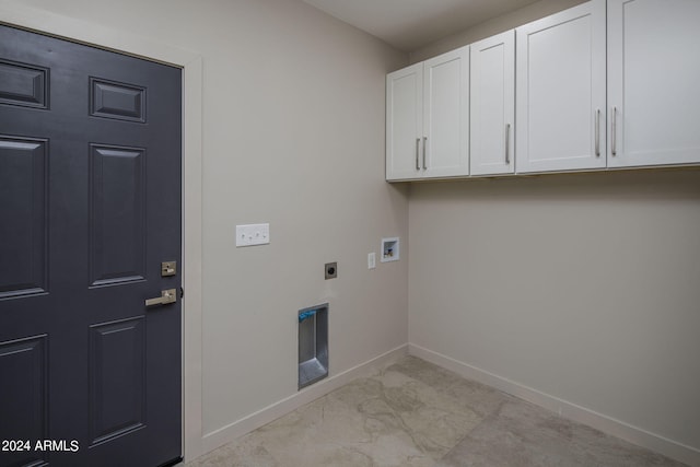 clothes washing area featuring hookup for a washing machine, cabinet space, electric dryer hookup, and baseboards