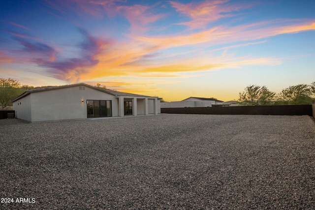 view of back of property at dusk