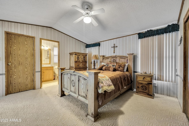 17124 E Fairway Dr, Mayer, AZ 86333 - bedroom with light colored carpet, lofted ceiling, ensuite bathroom, ceiling fan, and a textured ceiling