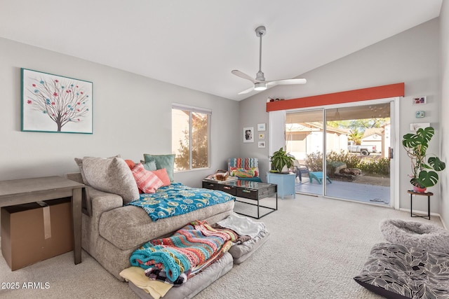 living area with ceiling fan, carpet, and lofted ceiling