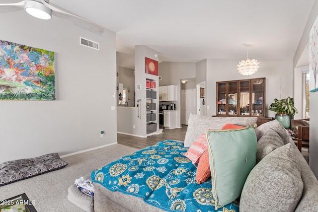 bedroom with carpet flooring, a chandelier, baseboards, lofted ceiling, and visible vents
