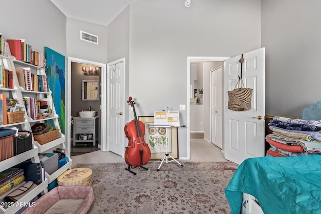 bedroom with carpet floors, visible vents, and a towering ceiling