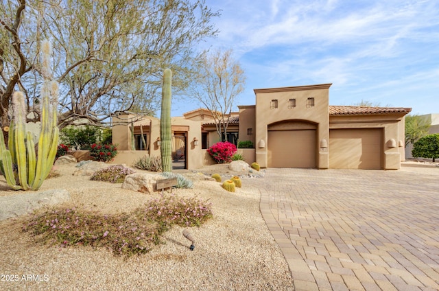 pueblo-style home with a garage