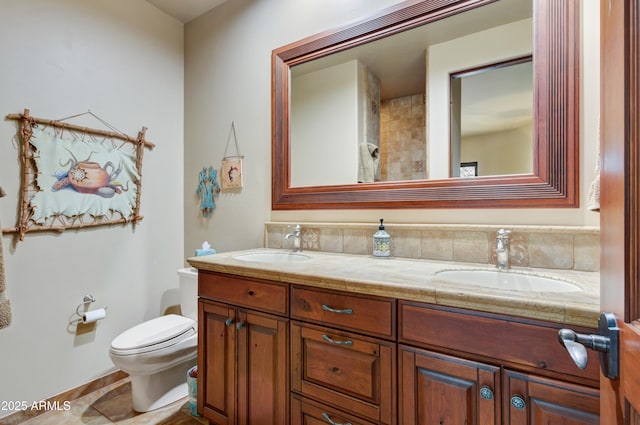 bathroom featuring vanity, toilet, and tile patterned flooring