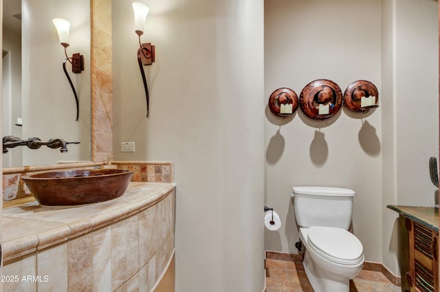 bathroom featuring vanity, tile patterned floors, and toilet