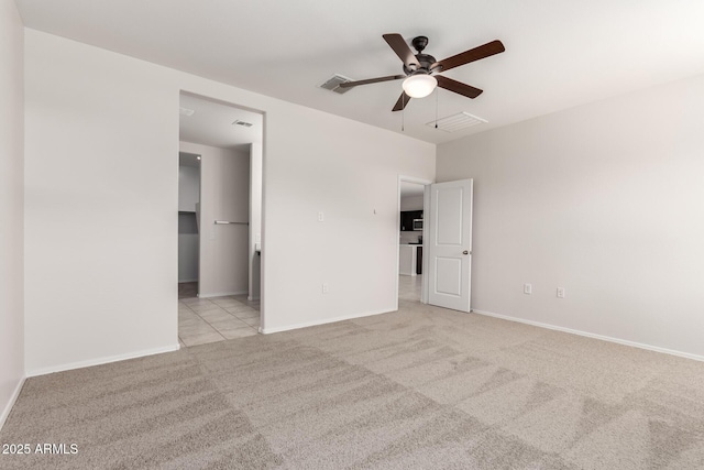 4713 W Nutmeg Ave, Coolidge, AZ 85128 - unfurnished bedroom featuring light colored carpet, ceiling fan, and a walk in closet
