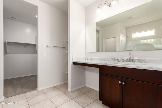 4713 W Nutmeg Ave, Coolidge, AZ 85128 - full bathroom with vanity, a spacious closet, and tile patterned flooring