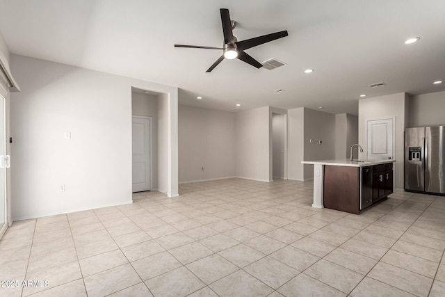 4713 W Nutmeg Ave, Coolidge, AZ 85128 - kitchen with stainless steel refrigerator with ice dispenser, ceiling fan, light countertops, open floor plan, and recessed lighting