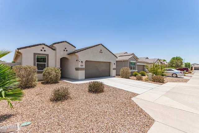 4713 W Nutmeg Ave, Coolidge, AZ 85128 - mediterranean / spanish house featuring stucco siding, a garage, and concrete driveway