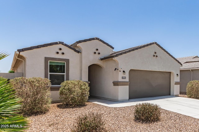 4713 W Nutmeg Ave, Coolidge, AZ 85128 - mediterranean / spanish home with a garage, stucco siding, concrete driveway, and a tile roof
