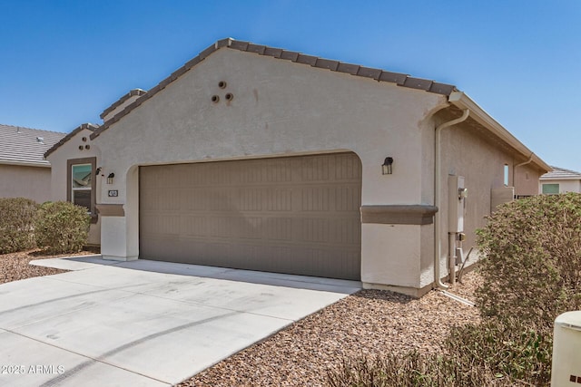 4713 W Nutmeg Ave, Coolidge, AZ 85128 - view of front facade with stucco siding, an attached garage, and driveway