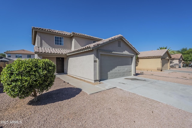 12813 W Paradise Dr, El Mirage, AZ 85335 - mediterranean / spanish house with stucco siding, an attached garage, concrete driveway, and a tile roof