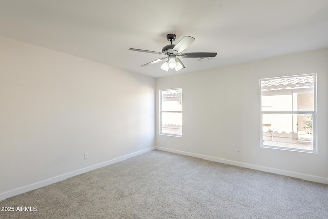 12813 W Paradise Dr, El Mirage, AZ 85335 - spare room featuring light colored carpet and a ceiling fan