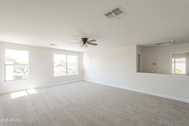 12813 W Paradise Dr, El Mirage, AZ 85335 - spare room featuring plenty of natural light, attic access, carpet floors, and a ceiling fan