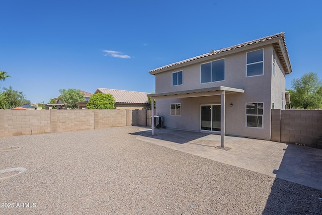 12813 W Paradise Dr, El Mirage, AZ 85335 - back of property featuring a fenced backyard, a patio area, and stucco siding