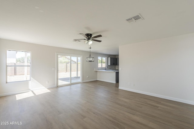 12813 W Paradise Dr, El Mirage, AZ 85335 - unfurnished living room with a ceiling fan and wood finished floors