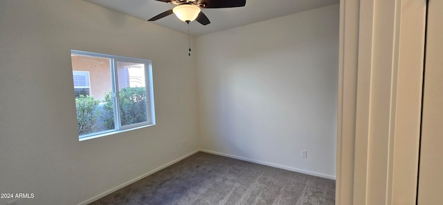 carpeted spare room with ceiling fan