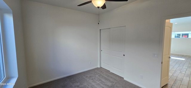 empty room featuring ceiling fan and carpet floors