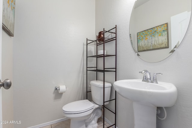 bathroom featuring tile floors and toilet