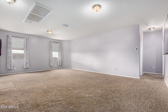 unfurnished room featuring light colored carpet