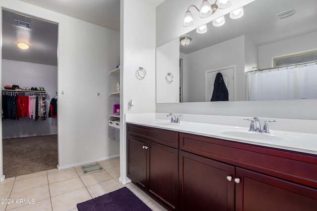 bathroom featuring tile floors and dual vanity