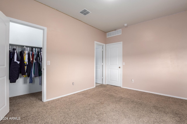 unfurnished bedroom with carpet flooring and a closet