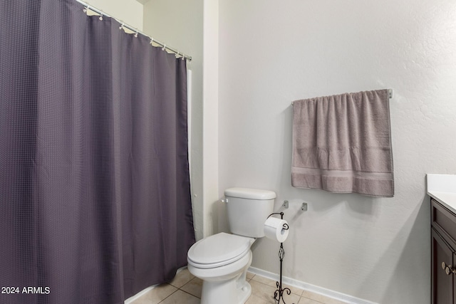 bathroom featuring vanity, tile flooring, and toilet