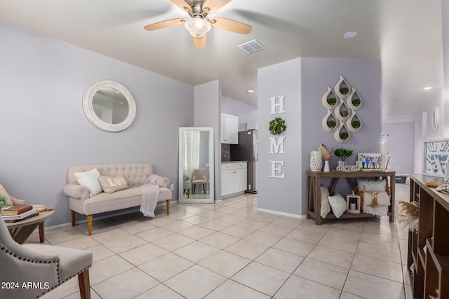 living room with ceiling fan and light tile flooring