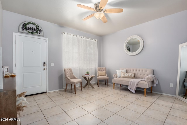 living area featuring ceiling fan and light tile floors